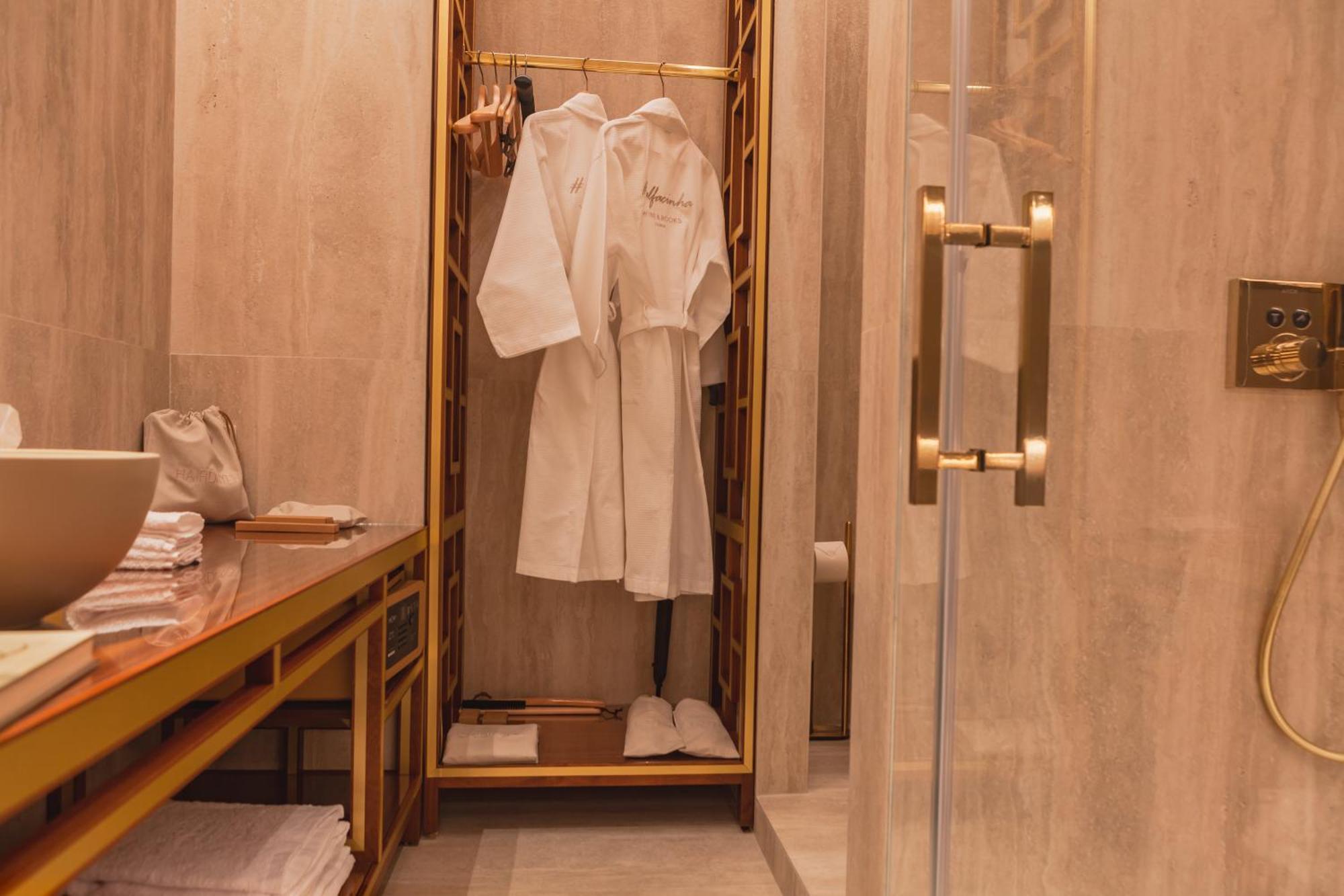 Wine & Books Lisboa Hotel Room photo A bathrobe in a hotel bathroom